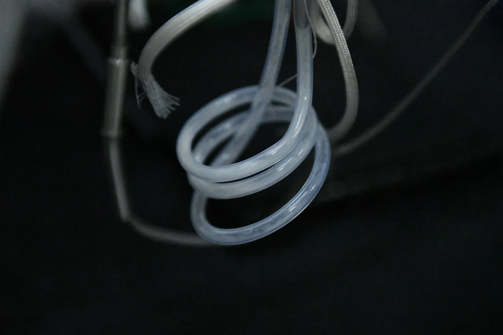 Uranium hexafluoride condensed as a white solid inside a coiled transparent line at Raven-Flint's Idaho Falls laboratory